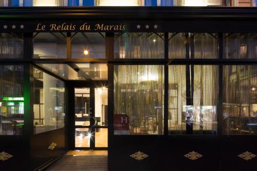 a store front of a store with glass doors at Le Relais du Marais in Paris