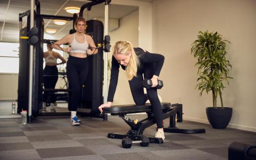 a woman sitting on a chair in a gym at WestCord Strandhotel Seeduyn in Oost-Vlieland