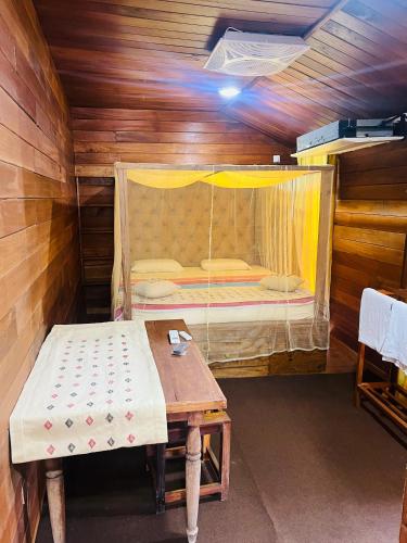 a small room with a bed and a table at Nisala Rest in Gampola