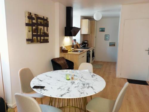 a kitchen and dining room with a table and chairs at L 'Échappée Marine au coeur de Concarneau in Concarneau