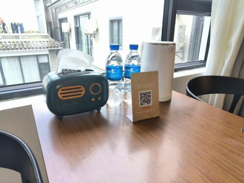 a table with a toaster and bottles of water on it at Prajna Pavilion in Dali Ancient Town