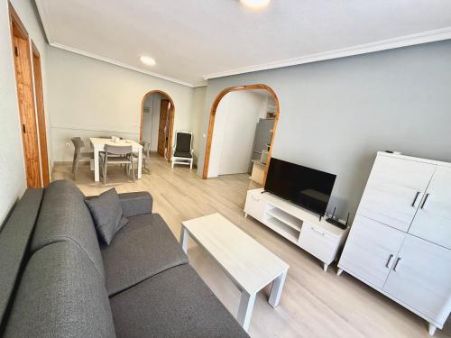 a living room with a couch and a table at Destinos De Sol Los Alcazares - Montepío Minería in Los Alcázares
