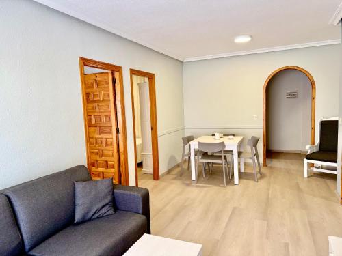 a living room with a couch and a table at Destinos De Sol Los Alcazares - Montepío Minería in Los Alcázares