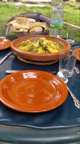 a table topped with plates of food and a pie at Auberge De La Vallée in Imlil