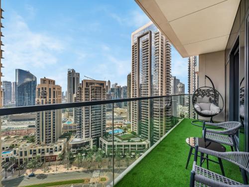 a balcony with chairs and a view of the city at The Chic Downtown Suite Luxury near Burj Khalifa in Dubai