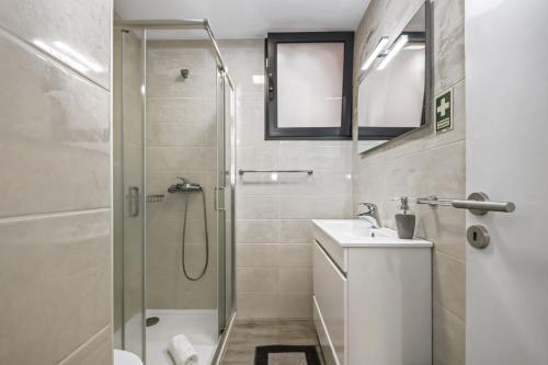 a bathroom with a shower and a toilet and a sink at Seaside Charm II in Câmara de Lobos