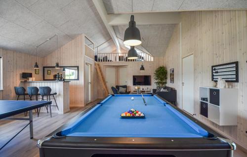 a pool table in the middle of a room at 8 Bedroom Beautiful Home In Grenaa in Grenå