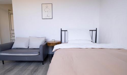 a bedroom with a bed and a chair at Prajna Pavilion in Dali Ancient Town
