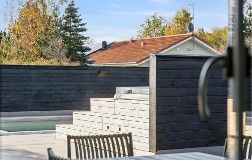 a house with a black fence and some stairs at Gorgeous Home In Højby With Kitchen in Højby