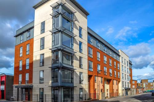 a tall brick building on a city street at Garden View Serviced Flat by Castle Park, Lift in Bristol