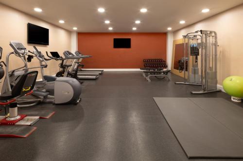a gym with several treadmills and exercise machines at Hampton by Hilton London Gatwick Airport in Horley