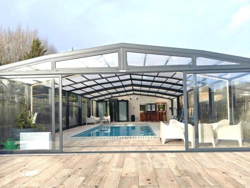 a glass pavilion over a swimming pool on a house at Château-ferme de Pondrome in Beauraing