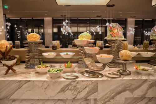 a buffet with bowls of food on a table at Braira Al Rass بريرا الرس in Al Rass