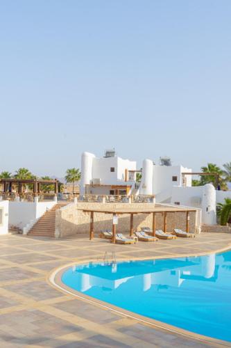 a view of a resort with a swimming pool at Sharm Club Beach Resort in Sharm El Sheikh