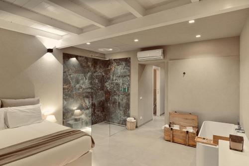a bedroom with a bed and a stone wall at Palermo Inn Boutique Hotel in Palermo