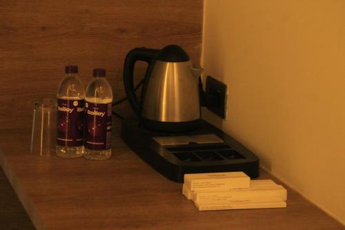 a coffee maker and two bottles of water on a counter at Hotel Sahyadri in Achād