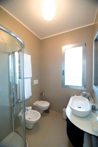 a bathroom with a sink and a toilet and a shower at The One Hotel - Designed for Adults - Pet lovers in Riccione