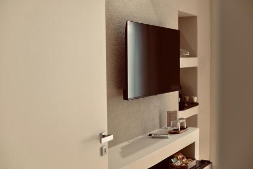 a bathroom door with a tv on the wall at Palermo Inn Boutique Hotel in Palermo