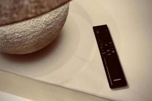 a remote control sitting on top of a plate at Palermo Inn Boutique Hotel in Palermo