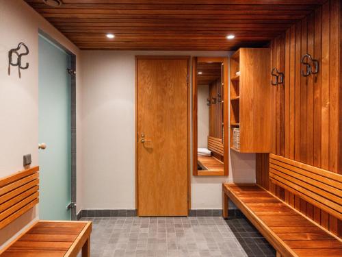 a row of wooden benches in a locker room at Santa's Villa Laavu in Kittilä