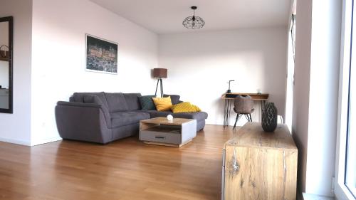 a living room with a couch and a table at Hotel Spree-idyll in Berlin