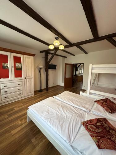 a large bedroom with a large bed with white sheets at Penzion 4 Dvory in České Budějovice