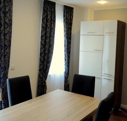 a conference room with a table and two chairs at Merkel Villa Apartamente in Wiesbaden