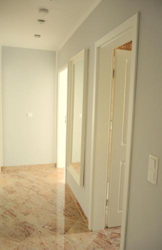 an empty room with a door and a mirror at Merkel Villa Apartamente in Wiesbaden