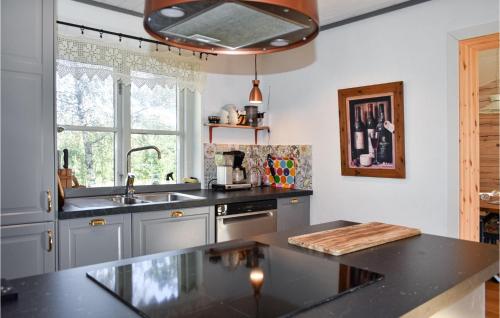 a kitchen with a counter top and a sink at Lovely Home In Simrishamn With Kitchen in Simrishamn