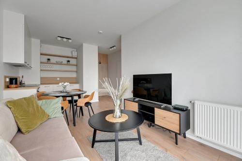 a living room with a couch and a table at GRANO FLATS - Sobieszewo - Baltic Porto in Gdańsk