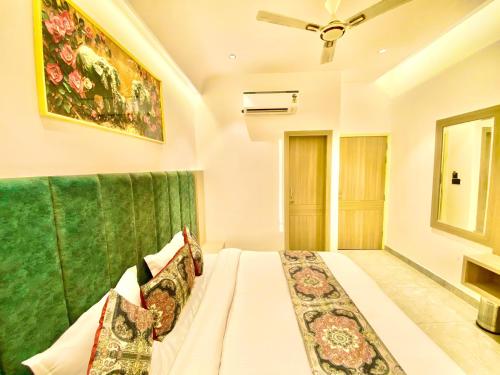 a bedroom with a bed with a green curtain at Park Plaza Hotel Near Golden Temple in Amritsar