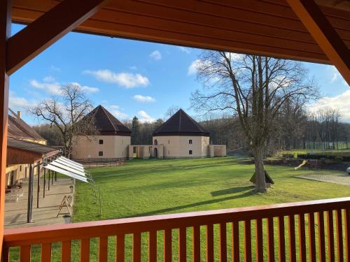 a view of a yard from the porch of a house at Zámecký Dvůr Černousy in V Poli
