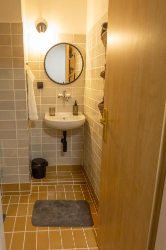 a bathroom with a sink and a mirror at Penzion Bistár in Habovka