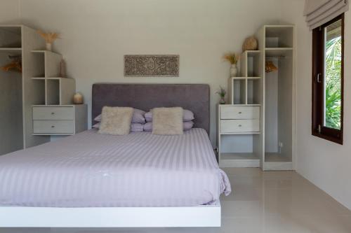 a bedroom with a large bed and two night stands at Baan Lily in Chaweng