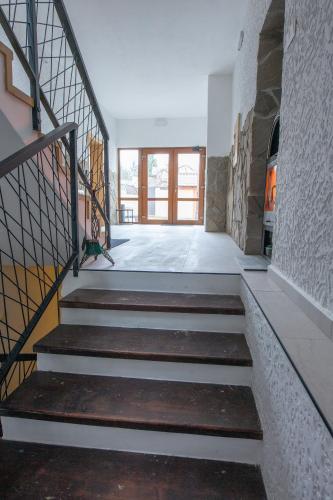 a staircase in a building with a stair case at Penzion Bistár in Habovka