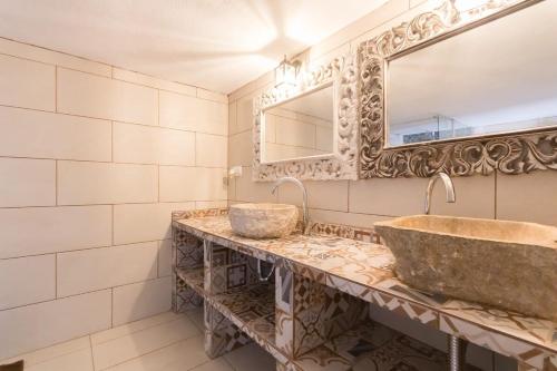 a bathroom with two sinks and a mirror at Classic Villa for 12- Pool, BBQ, big exterior area in Illes Balears