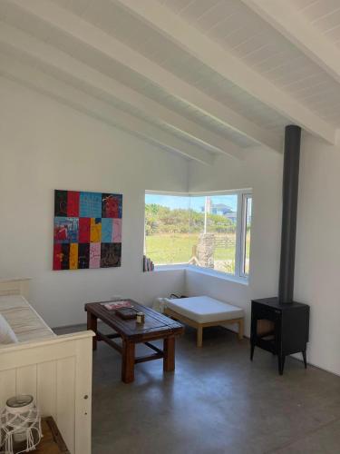 a living room with a table and a fireplace at Ola Santa in Colonia Chapadmalal