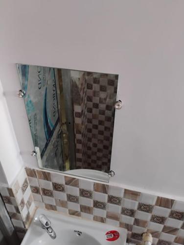 a bathroom with a mirror and a sink at Geeta Teerth Guest House AC and Non AC Rooms in Ayodhya