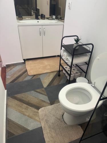a bathroom with a toilet and a sink at Compact House in Cluj-Napoca