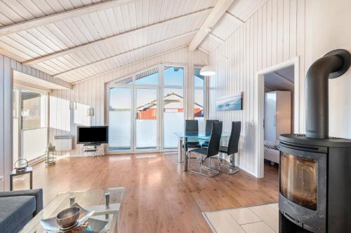 a living room with a wood stove and a table at Ferienhaus Aquamarin in Wesselburenerkoog