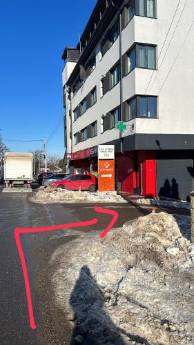 a red arrow on a street in front of a building at Complex Rediu 54 Luxury Apartaments in Iaşi
