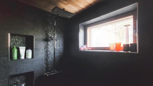 a bathroom with a window with a sink and a window at Cozy guesthouse with sauna, private entrance in Sodankylä
