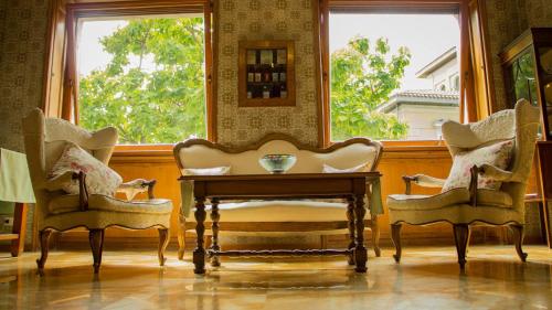 a room with two chairs and a table and a window at Locanda dei Buoni e Cattivi in Cagliari