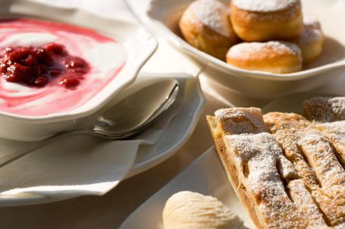 a table with a plate of food with dip and pastries at Parc Hotel Flora S in Riva del Garda