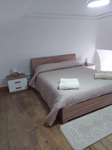 a bedroom with a large bed and a wooden floor at GuestHouseChampagne in Boscotrecase