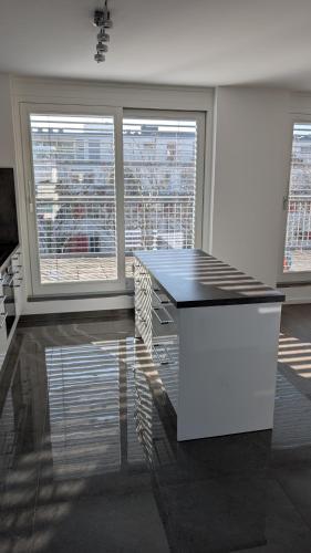 a white room with a table and two windows at Doppelzimmer in großer Wohnung oberste Etage zentral gelegen DoubleBedroom in spacious Apartment on top floor central Munich in Munich