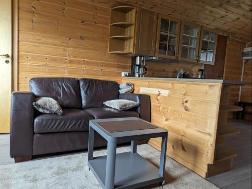 a living room with a couch and a table at Hardangerfjord panorama 1 in Kvam