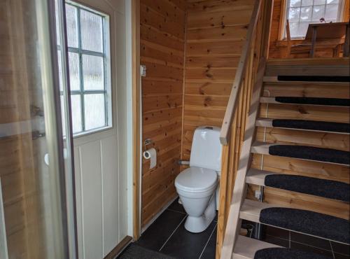 a bathroom with a toilet in a wooden house at Hardangerfjord panorama 1 in Kvam