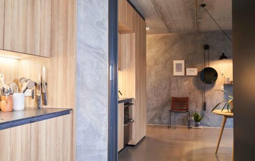 a room with a kitchen with a counter top and a room with at Hotel GUESTapart in Aarhus