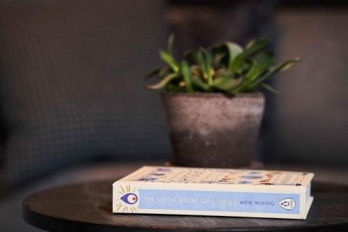 a pizza box sitting on top of a table with a plant at Hotel GUESTapart in Aarhus